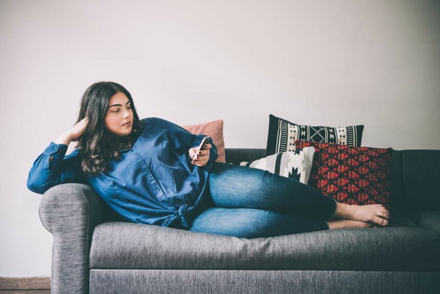 Plus size woman lounging on couch