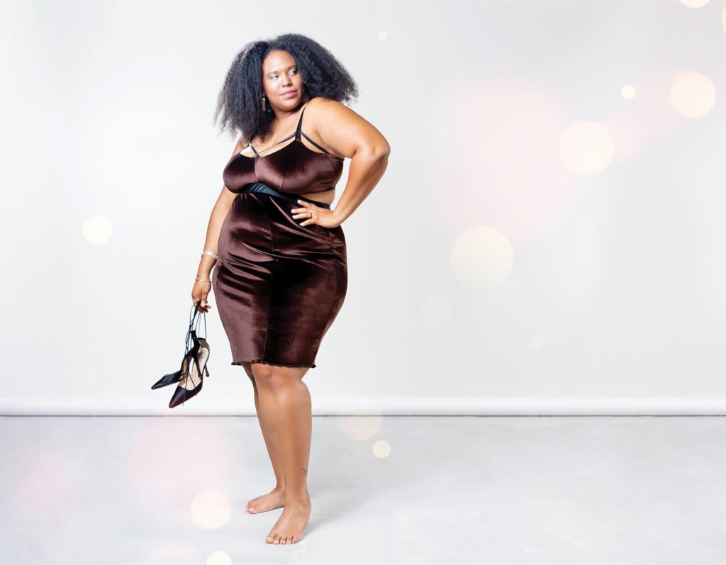 Plus size woman of color modeling Impish Lee