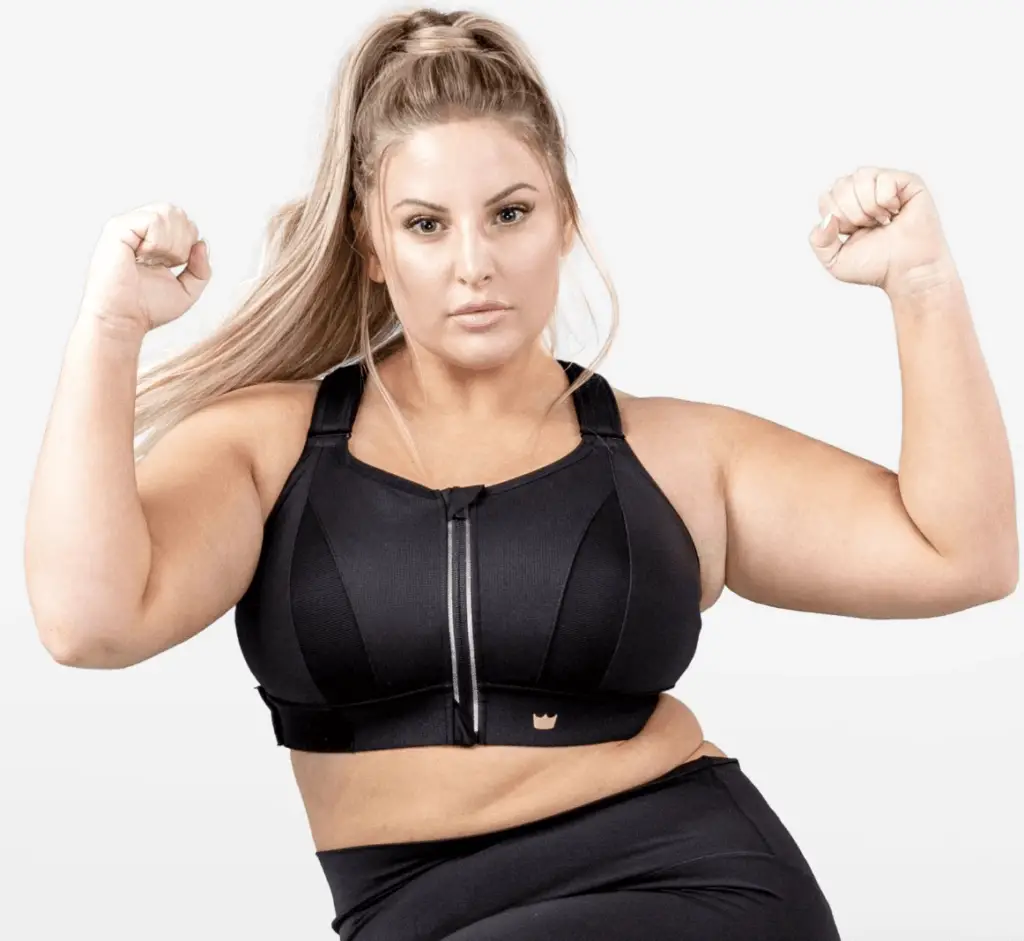 Woman plus size in gym doing exercises with training apparatus