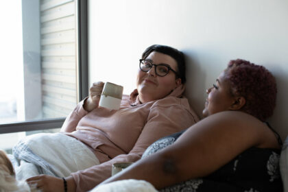 Plus size couple laying in bed