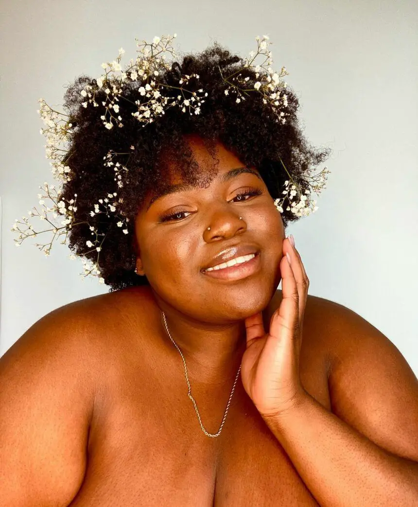 Beautiful happy plus size sexy woman with curly hair in light blue