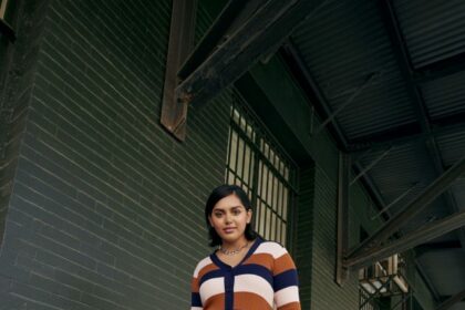 Woman in ELOQUII Elements striped dress.