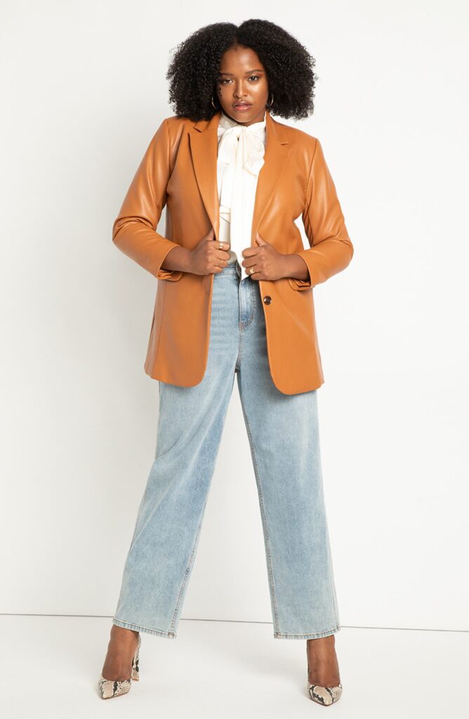 Woman wearing a dark orange colored faux leather blazer