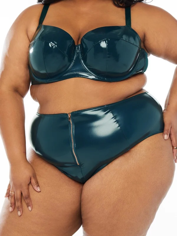 a plus size woman in a vinyl green bra and short set 