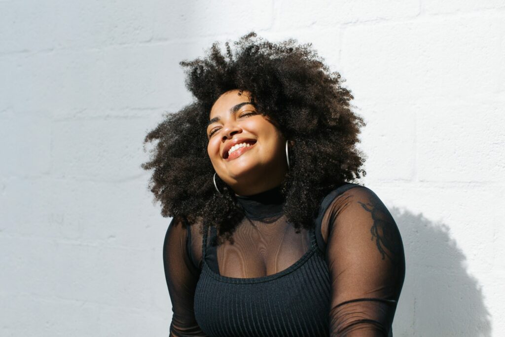 Black plus size woman smiling while talking about a New Year's Theme