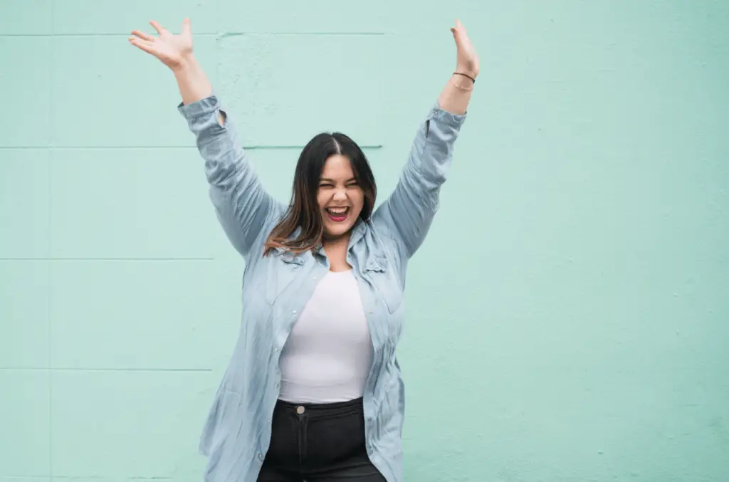 Young plus Size Woman Celebrating Victory. Photo