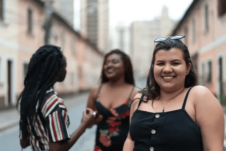Image of three young ladies standing together smiling