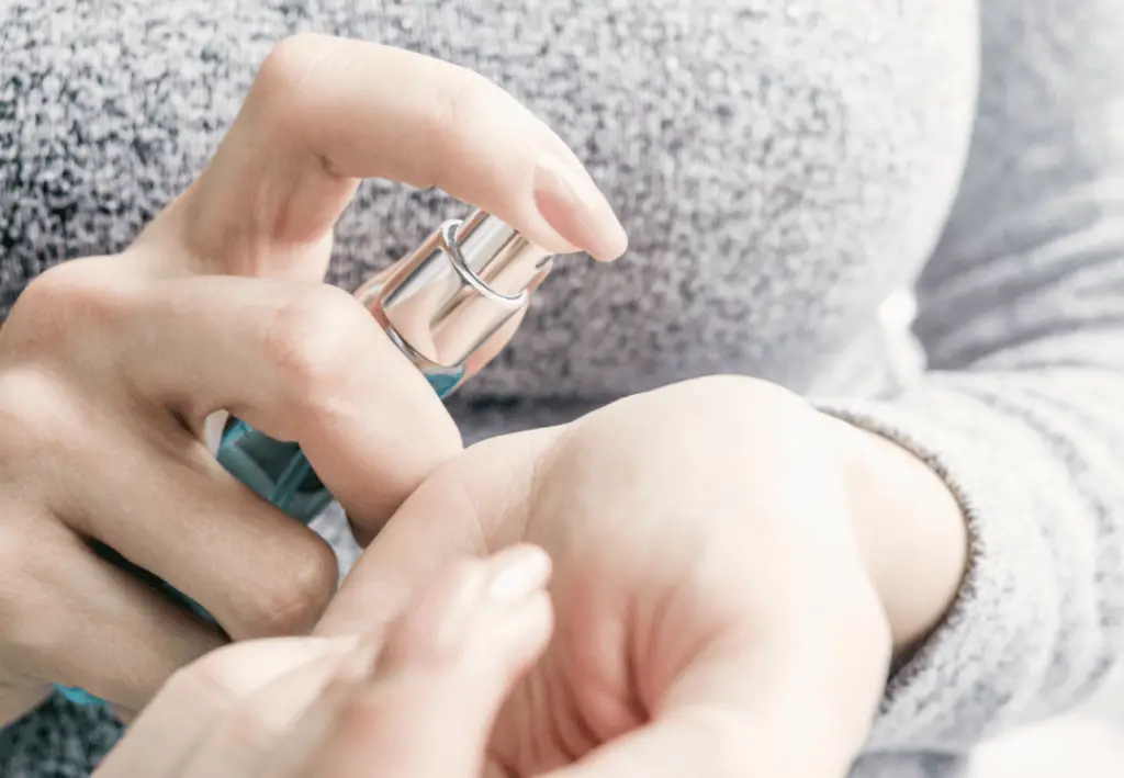 Woman hands holding perfume