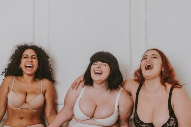 Three plus size women laughing happily