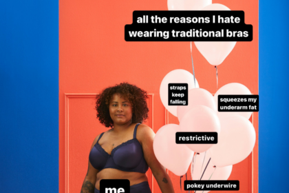 brown-skinned plus size woman in traditional underwire bra holding balloons in front of red door looking into camera holding balloons representing reasons people hate bras