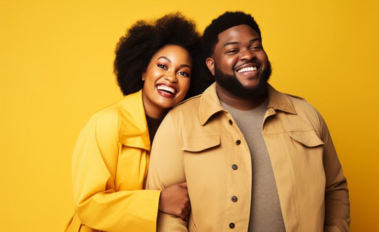 Happy smiling african american plus size couple standing together against a plain yellow background, isolated