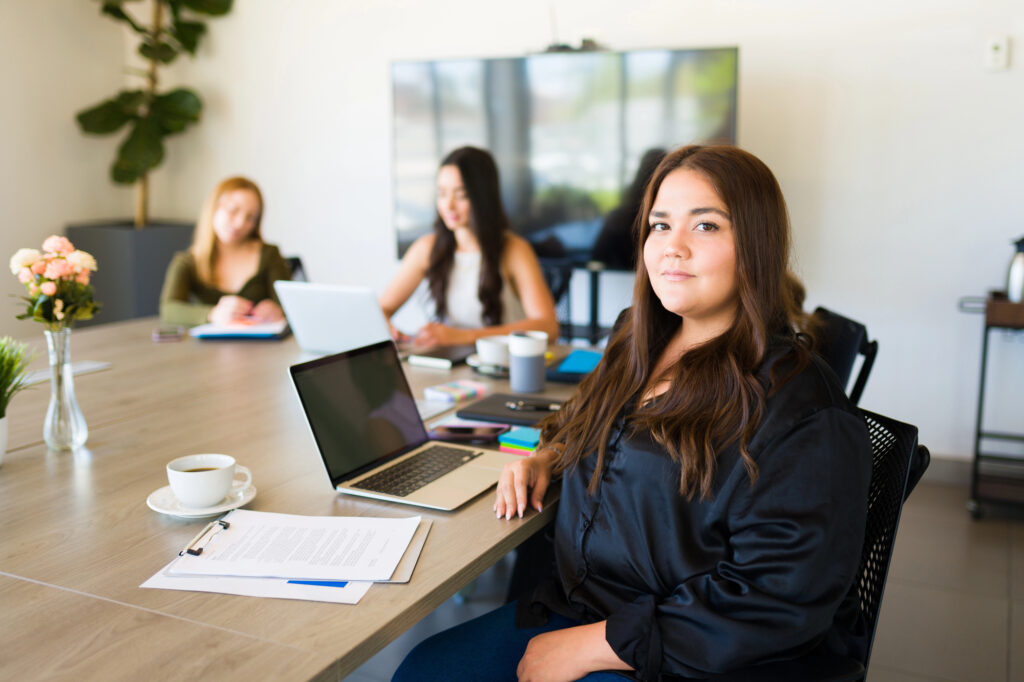 plus size leadership plus size woman at work with coworkers