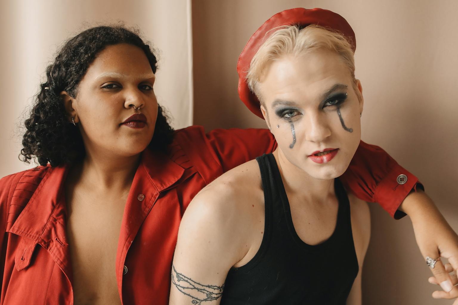 A striking portrait of two stylish friends with bold makeup, showcasing diversity and fashion in a studio setting.
compliments plus size women want