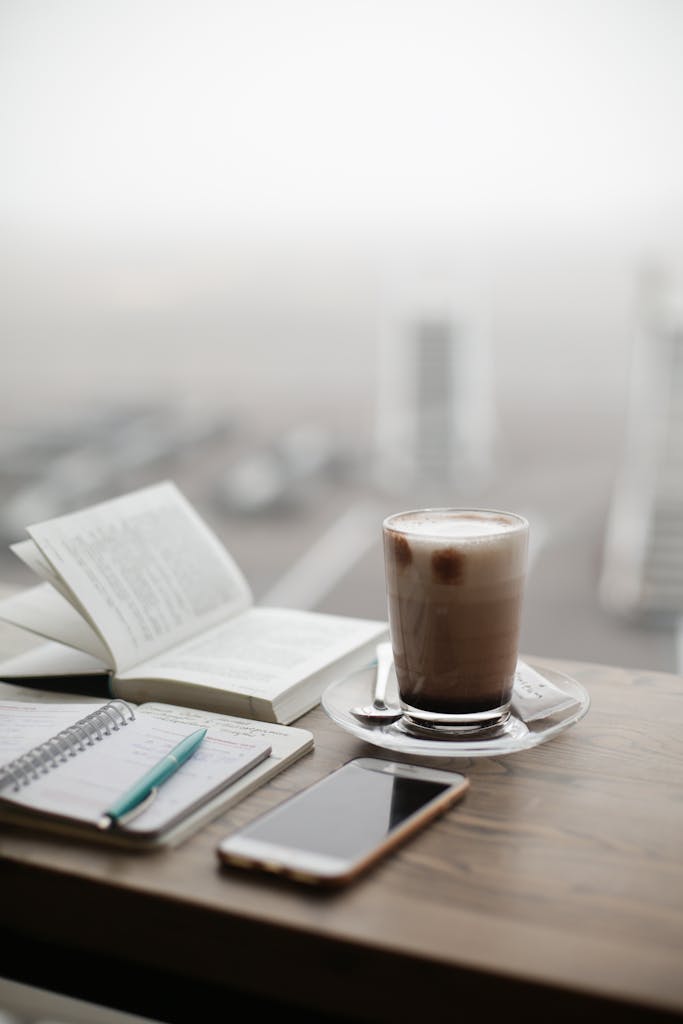 A warm coffee sits beside a notebook and smartphone on a foggy day.

what I’m carrying into the new year