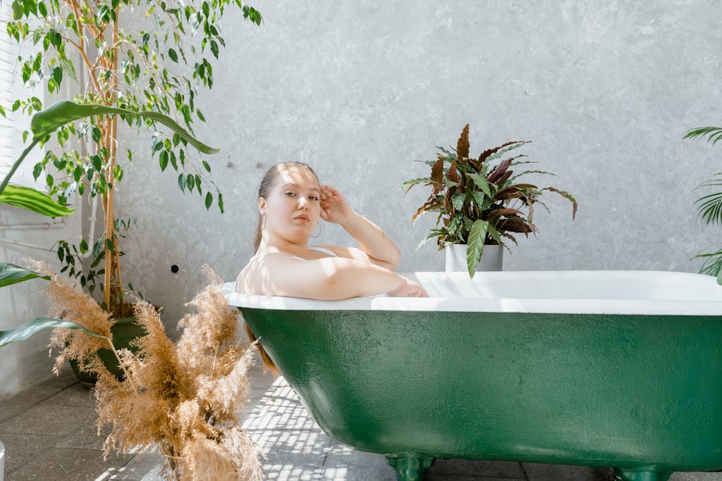 Peaceful scene of a woman relaxing in a green bathtub surrounded by indoor plants.

new year theme instead of resolutions
