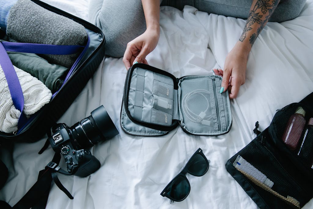Traveler organizing essentials including a camera and packing cubes on a hotel bed.
5 Plus Size Travel Packing Tips That Make Every Trip Easier