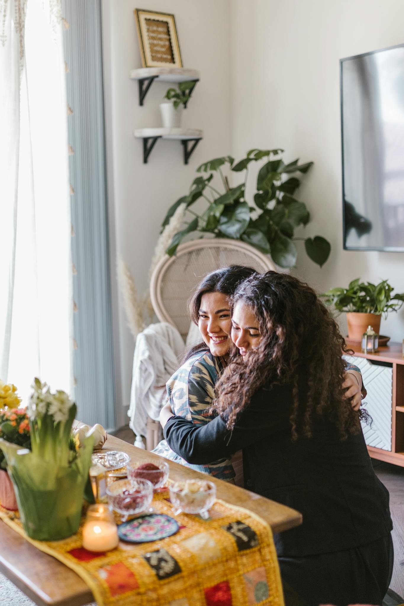 Two women embrace joyfully indoors during a Nowruz celebration with a traditional table setting.
compliments plus size women want