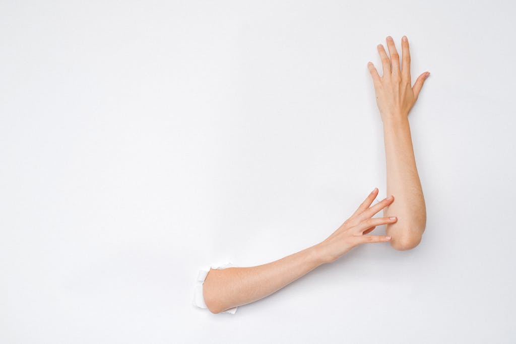 A creative and artistic image of hands extending from a hole in a white wall, highlighting human expression.

plus size confidence in 2026