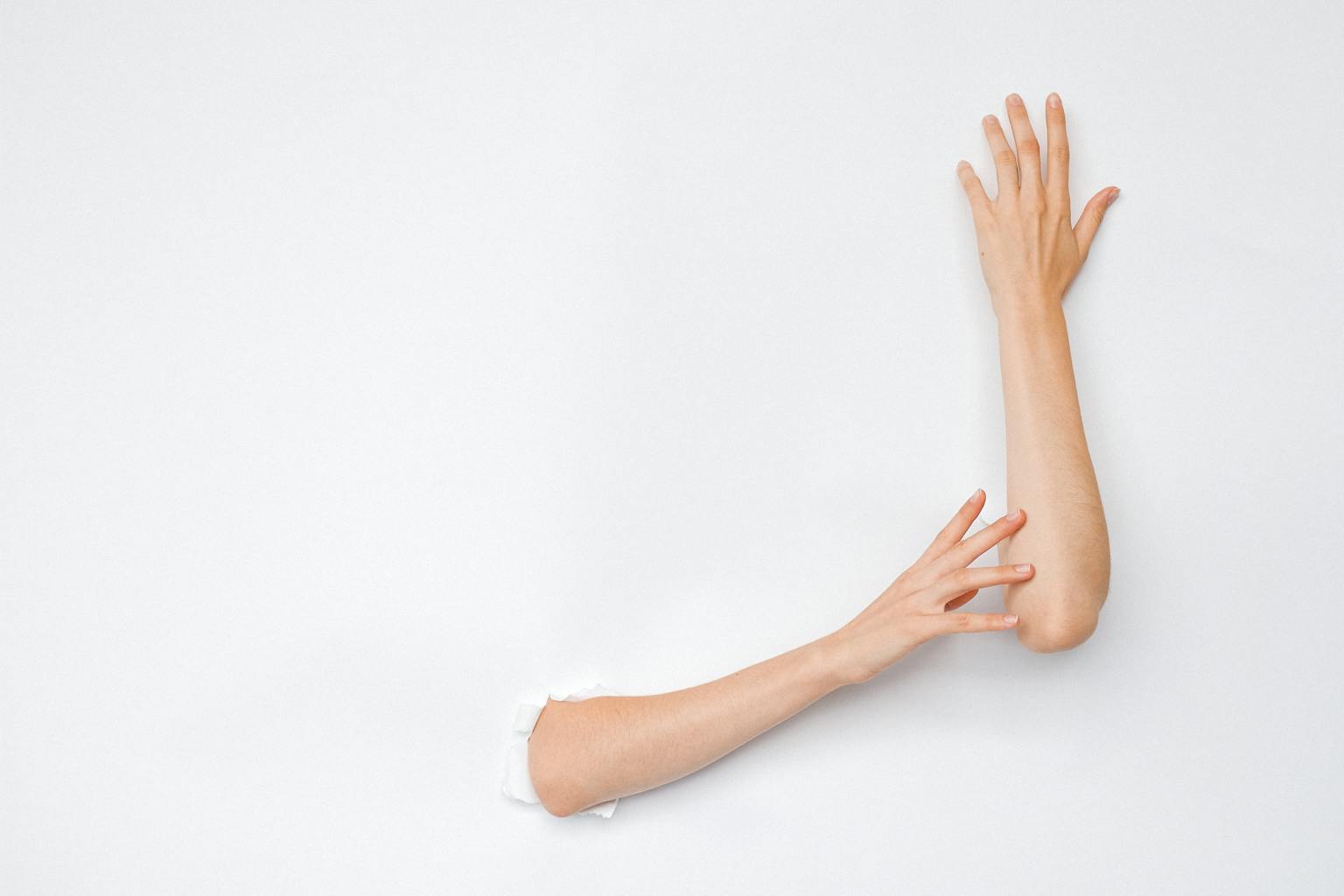 A creative and artistic image of hands extending from a hole in a white wall, highlighting human expression.
plus size confidence in 2026