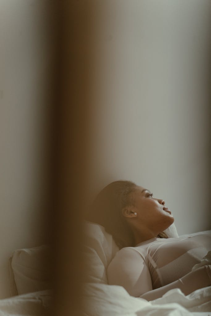 A serene image of a body positive plus size model lying indoors, showcasing relaxation.

radical self care for plus size people