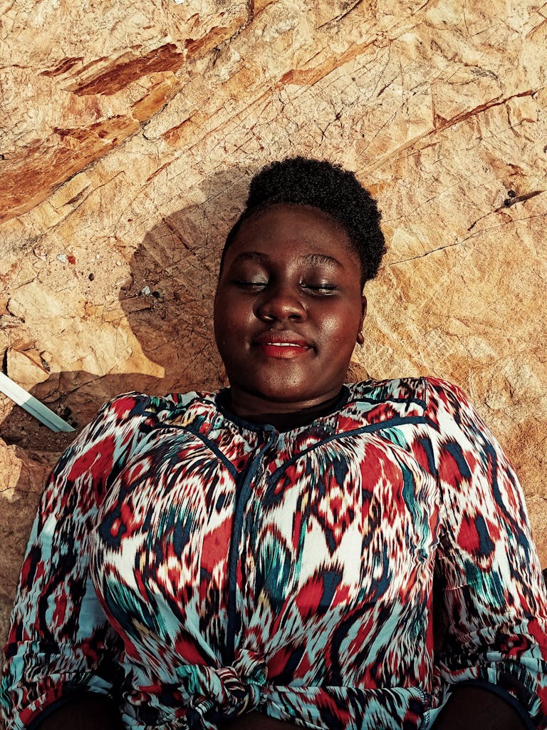 From above of positive plus size African American female with afro hairstyle wearing colorful shirt and lying on stony surface with eyes closed

plus size confidence in 2026