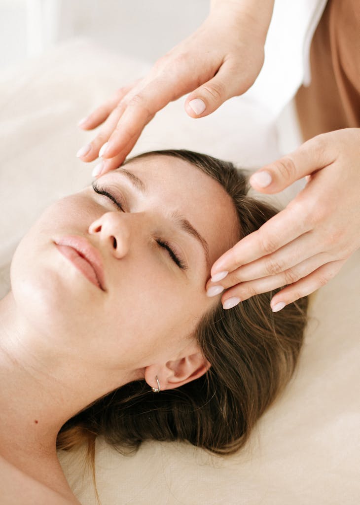 Woman receiving a soothing facial massage in a relaxing spa environment.
