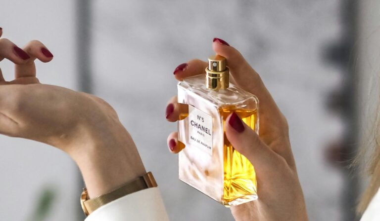 Close-up of a woman applying perfume on her wrist. Elegant and sophisticated.