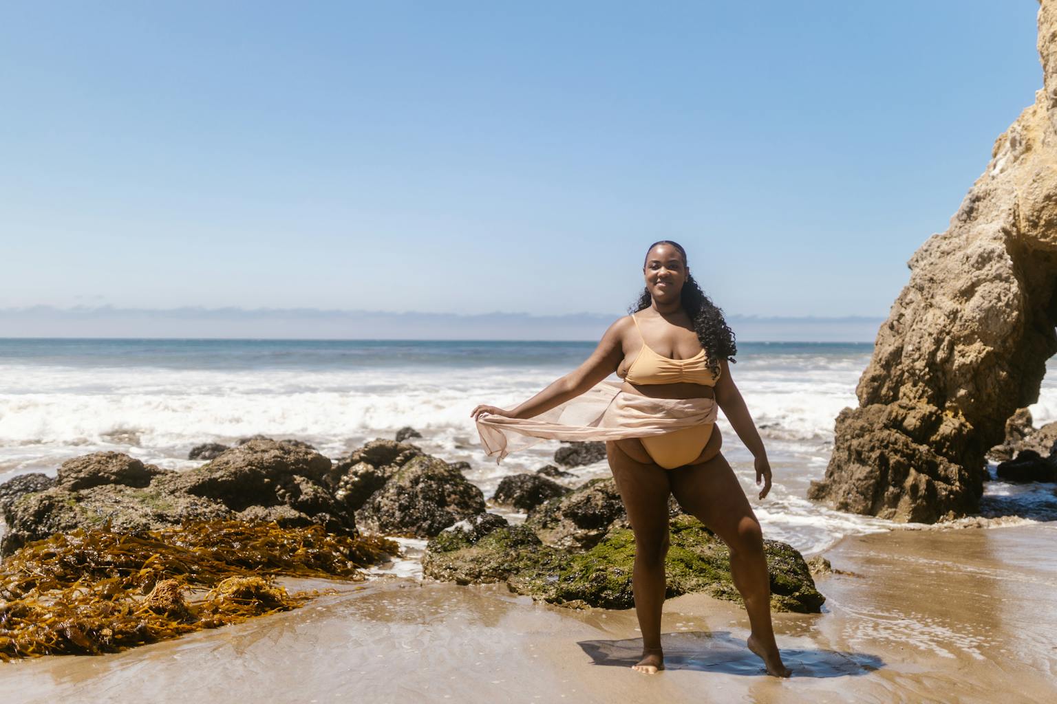 A joyful woman in swimwear poses on a rocky beach under the summer sun.
5 Plus Size Swimsuit Tips That Will Change How You Shop in 2026