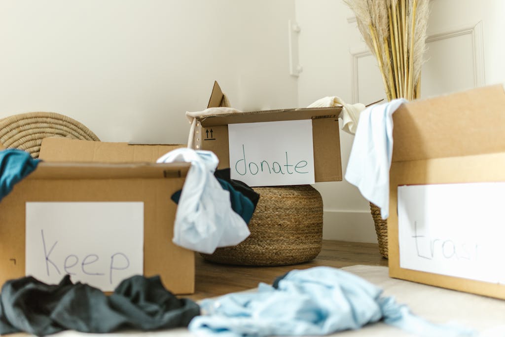 Cardboard boxes labeled Keep, Donate and Trash for effective home organization.