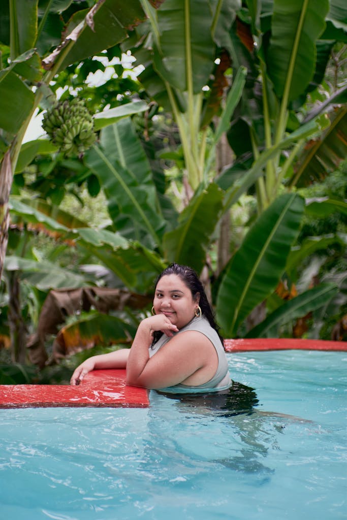Woman enjoying a serene swim in a tropical pool, surrounded by vibrant banana plants.

5 Plus Size Swimsuit Tips That Will Change How You Shop in 2026