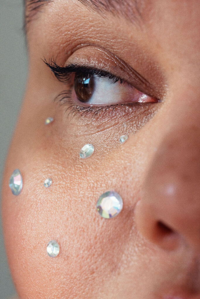 Close-up editorial portrait of Kartanya Maynard wearing rhinestone makeup details around her eye.

kartayna Maynard plus size representation 