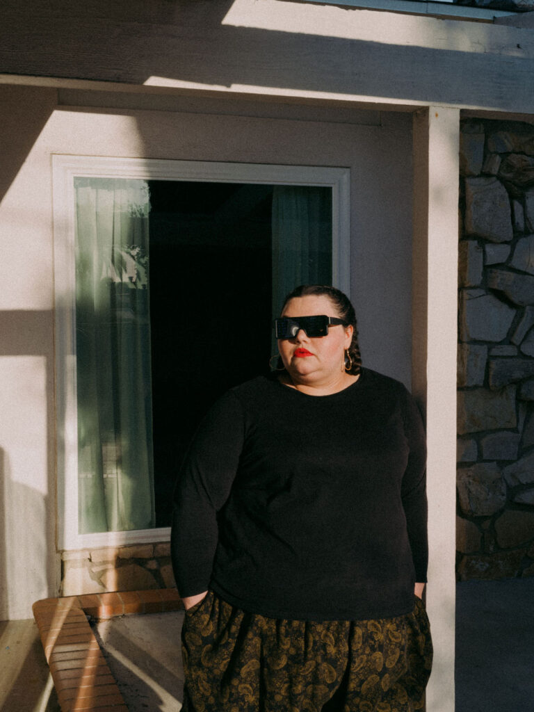 Kartanya Maynard wearing sunglasses and a black outfit during a fashion-forward editorial photoshoot.

Kartanya Maynard plus size representation