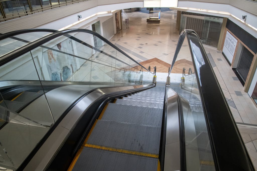 An escalator inside a deserted shopping mall with closed storefronts and empty spaces, capturing urban decay.

Size inclusivity in fashion