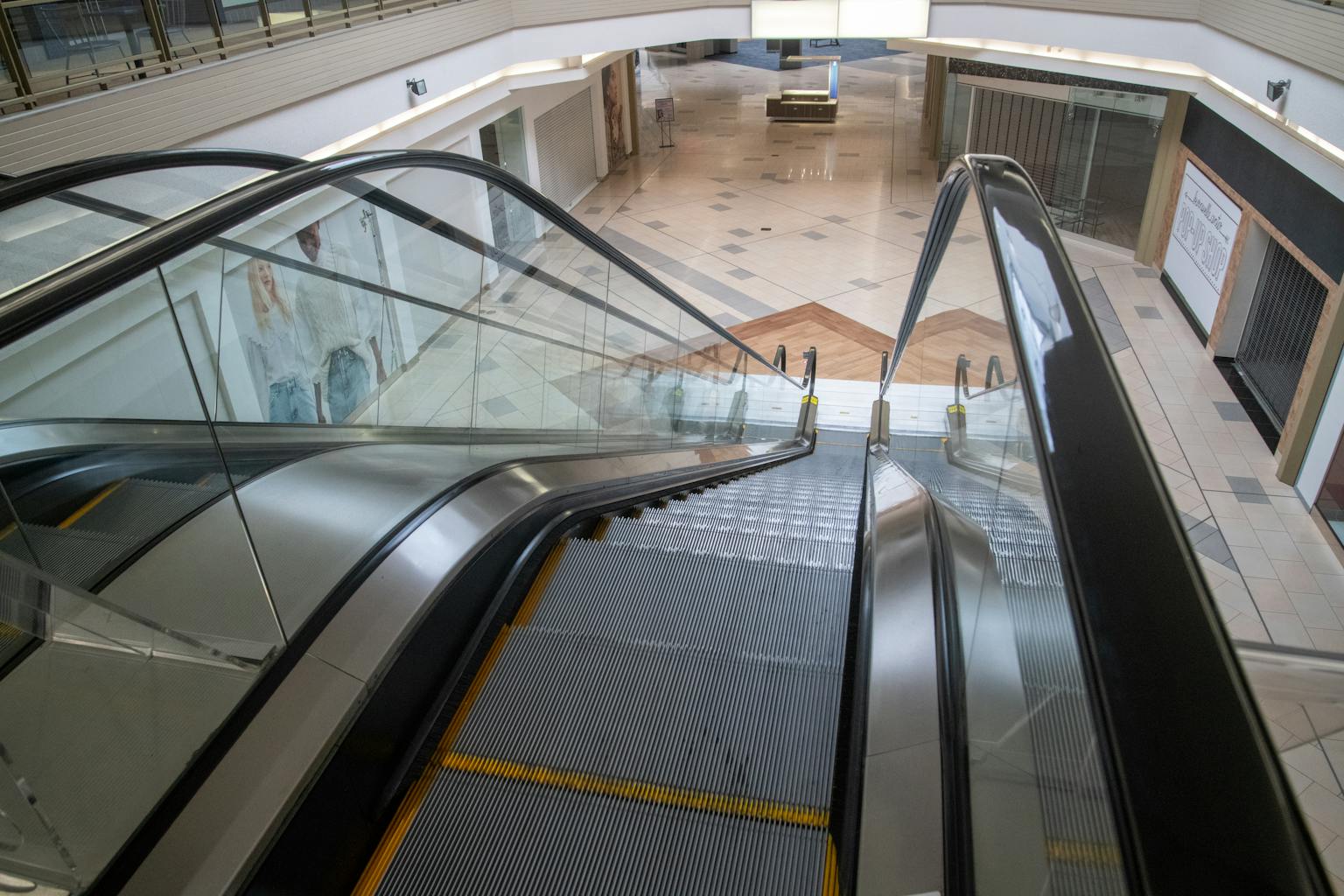 An escalator inside a deserted shopping mall with closed storefronts and empty spaces, capturing urban decay.
Size inclusivity in fashion
