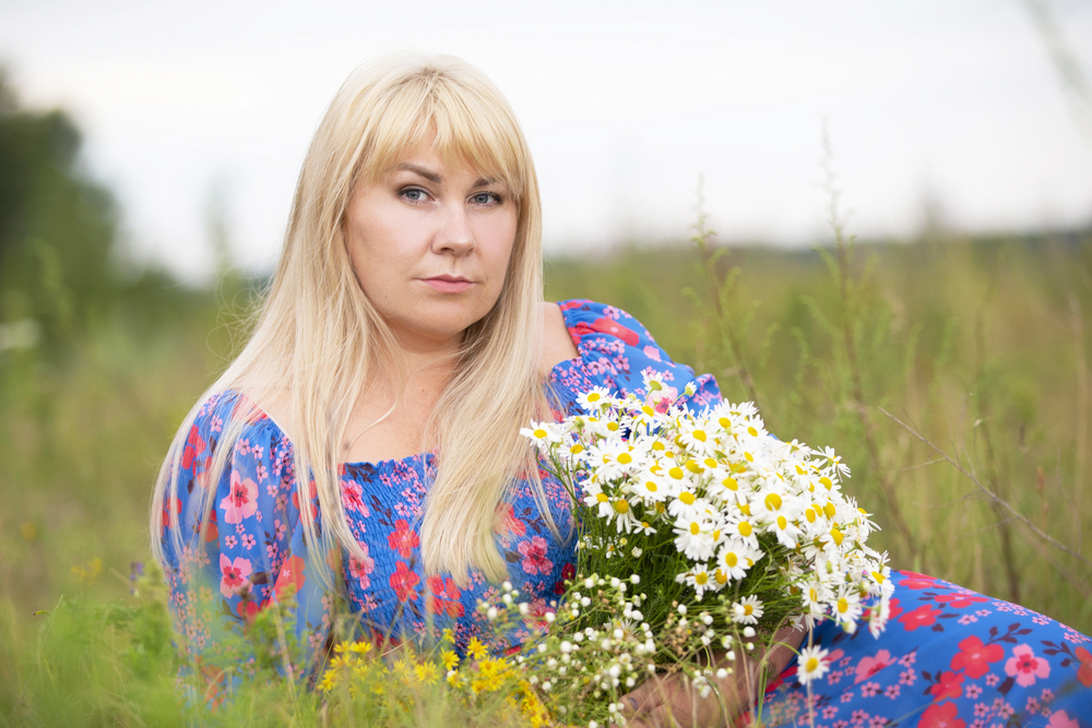 A beautiful plus size girl with white hair in a summer dress