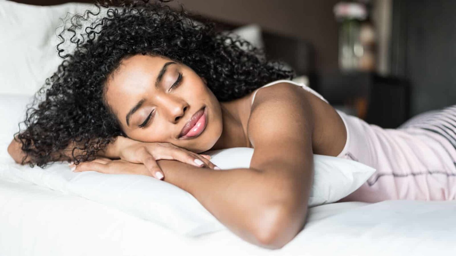 Beautiful black woman getting a good nights sleep. Image credit David Prado Perucha via Shutterstock