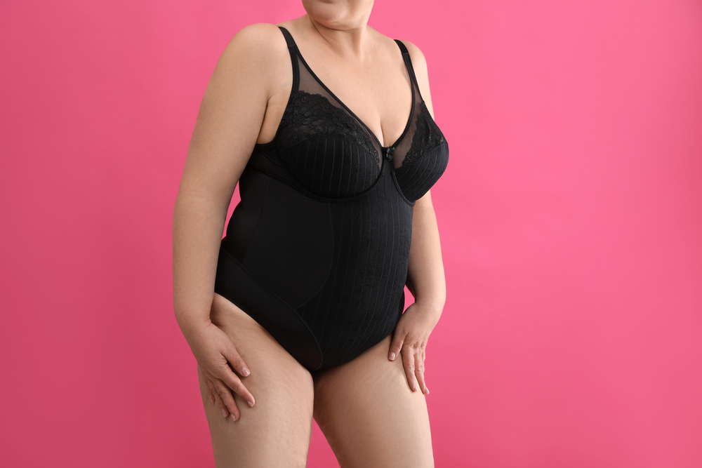 Overweight woman in black underwear