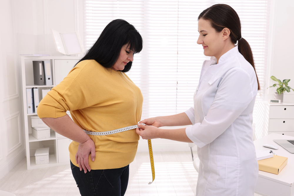 Plus size woman measured for a dress