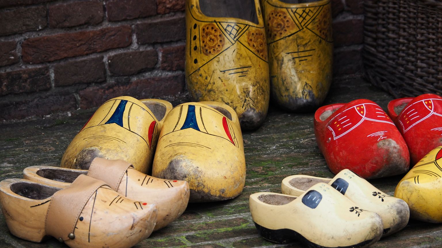 Colorful Dutch clogs arranged outdoors, showcasing unique traditional designs.