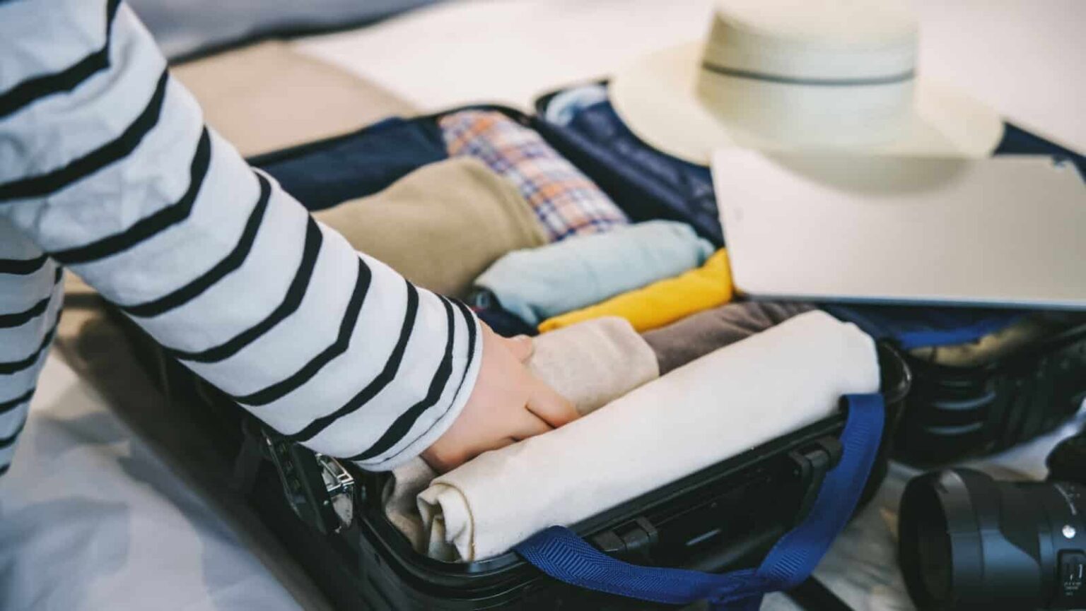 rolling clothing. packing. 4045 via Shutterstock