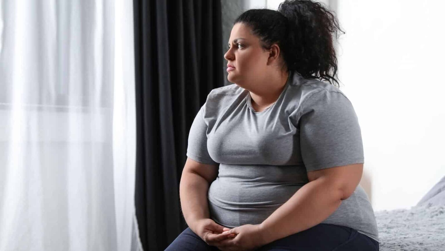 sad fat woman. New Africa via Shutterstock