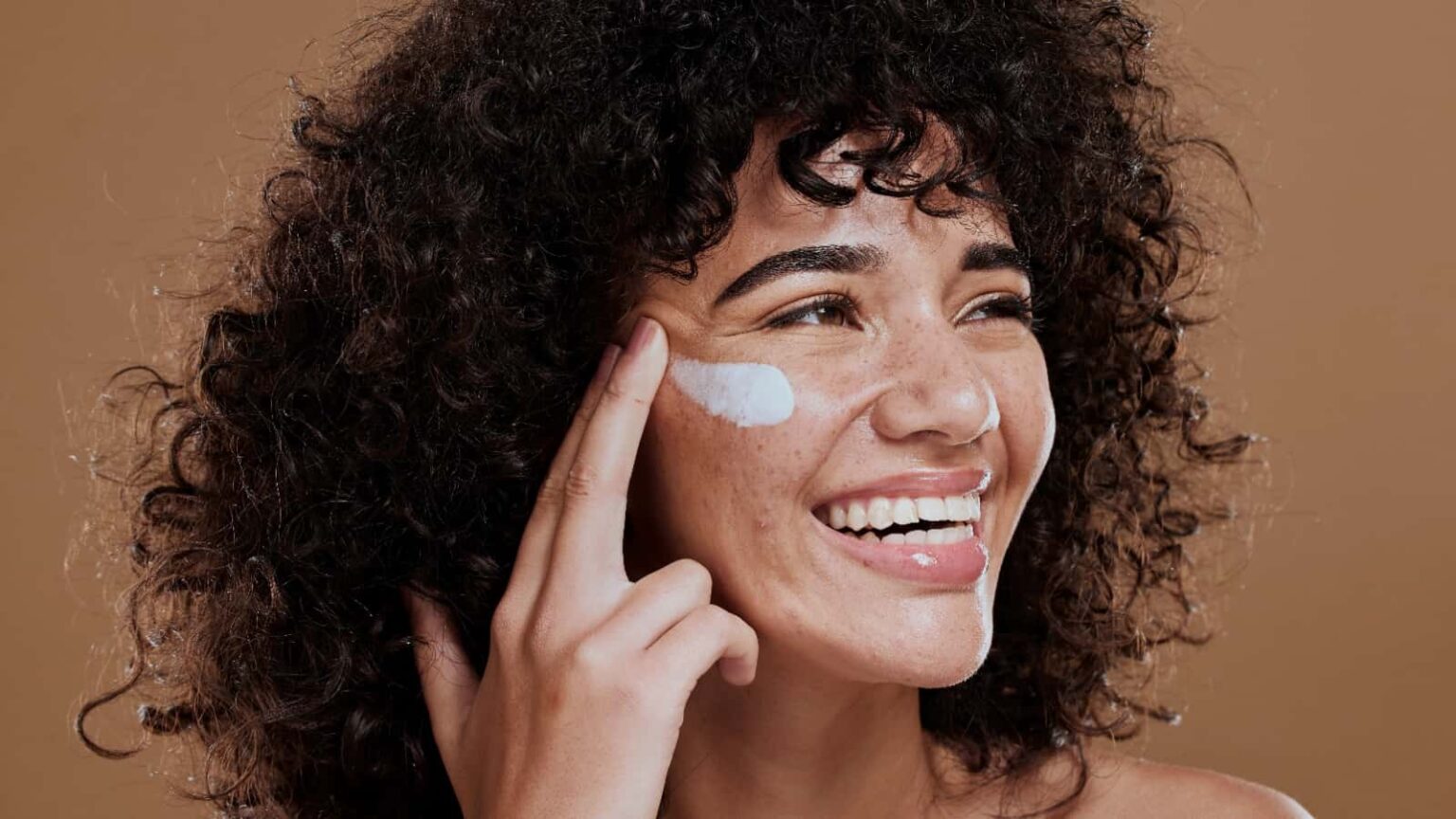 woman applying face cream. Image credit PeopleImages.com Yuri A via Shutterstock