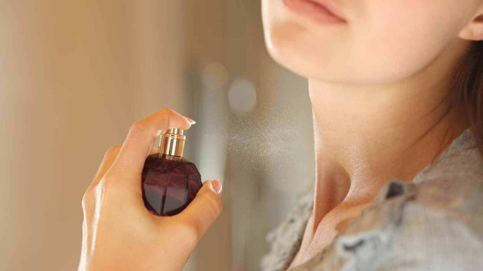 woman applying perfume