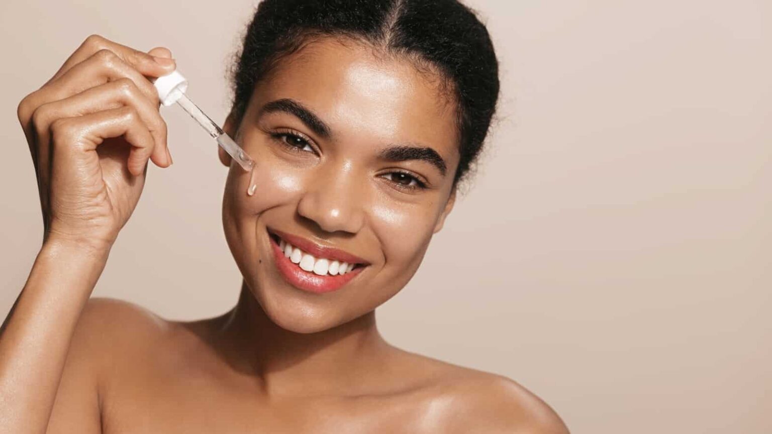 woman applying serum. Image credit Lyubov Levitskaya via Shutterstock