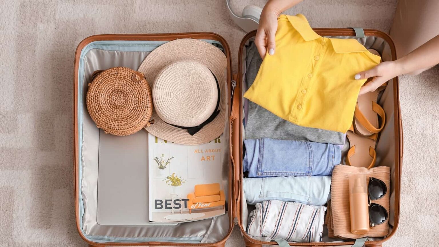 woman packing suitcase. Image credit Pixel Shot via Shutterstock